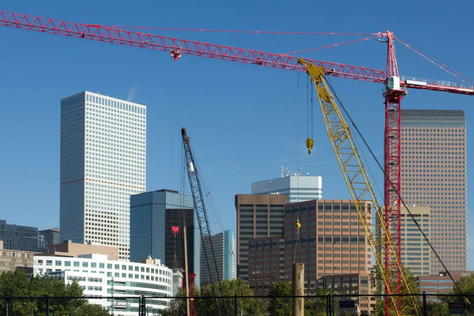 Construction crane in foreground, Denver skyline in background
